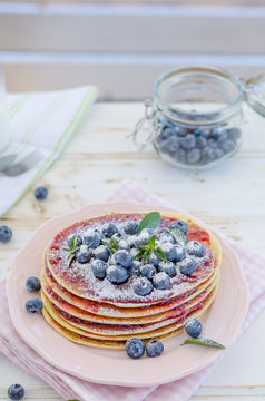 Vintage pancakes outside garden with blueberries