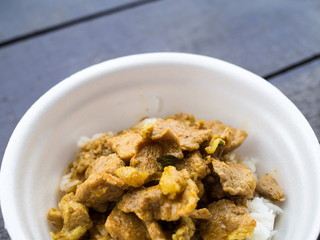 Close up red curry pork with rice in foam cup