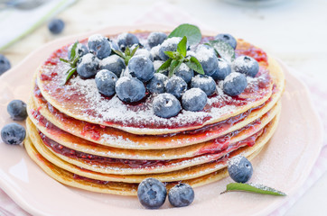 Vintage pancakes outside garden with blueberries