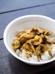 Red curry pork with rice in foam cup, Vertical view