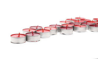 Tea light candles in aluminum candle holders isolated on white background