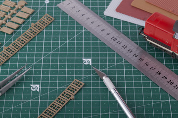 Creating train layout with tools on cutting mat