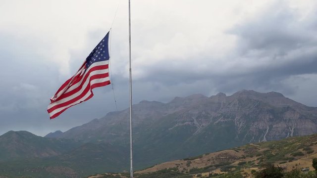 American Flag At Half-mast Blowing In The Wind For Death Of An Officer In The Line Of Duty.