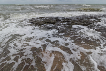 wave with stone at sea