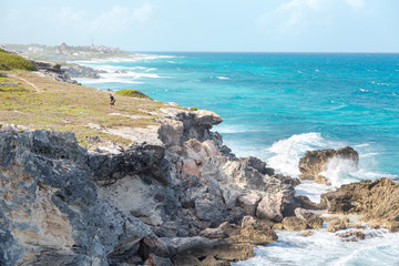 Fototapeta na wymiar A man near a ocean-side cliff on Isla Mujeres.
