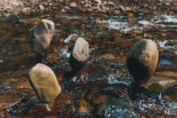 balance rocks in mountains river stream