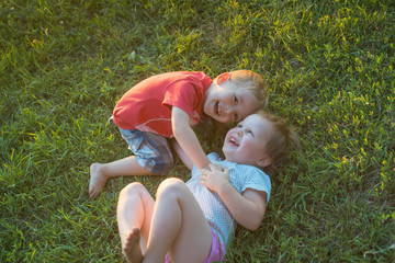 Two children playing on the green lawn