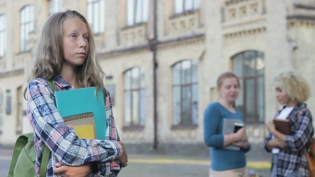 Beautiful modest girl teen having low self-esteem, arrogant classmates laughing