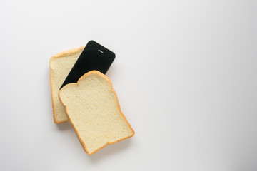 concept eat bread with a smartphone on white background.