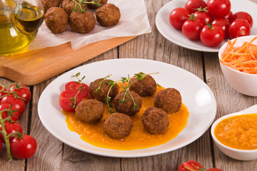 Meatballs with mashed carrots.