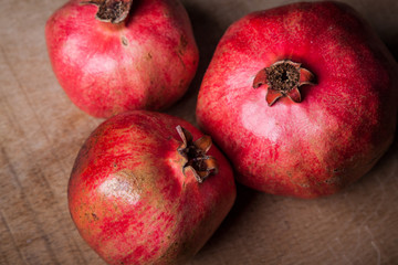 ................34/5000.....pomegranates on a wooden table..............