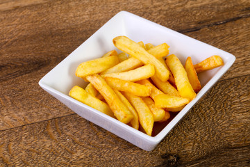 French potato over wooden background