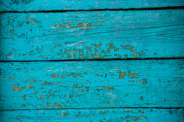 Wooden horizontal background with blue minty color texture. Paint cracked in small square shape