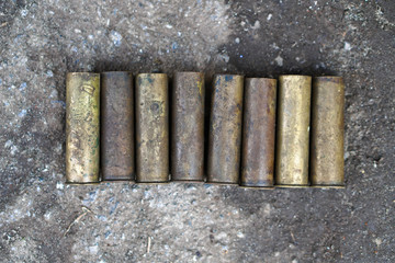 Sleeve from the gun on the background of a concrete structure. Military and hunting subjects for design. Terrorism and banditry