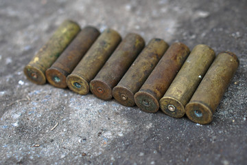 Sleeve from the gun on the background of a concrete structure. Military and hunting subjects for design. Terrorism and banditry