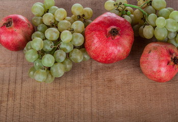 pomegranates grapes on a wooden table