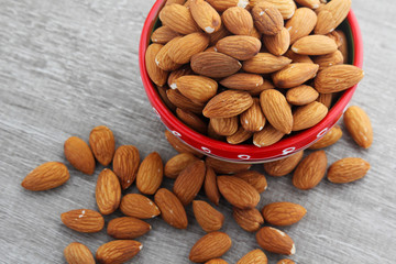 A ceramic bowl full of almonds