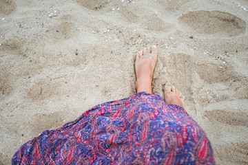 Legs of a girl in a sarafan