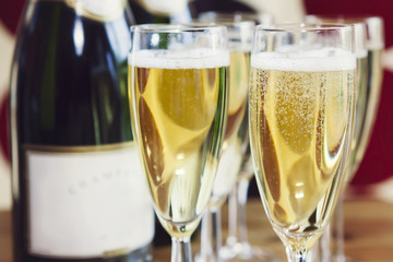 Bubbly champagne in glasses, with bottle
