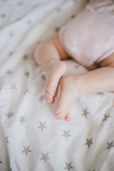Little baby feet on a swaddle blanket