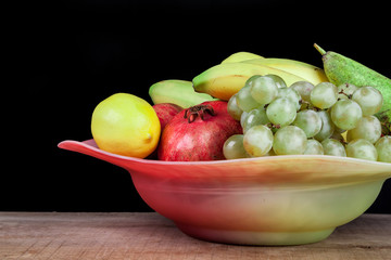 pomegranates and other fruits in a bowl