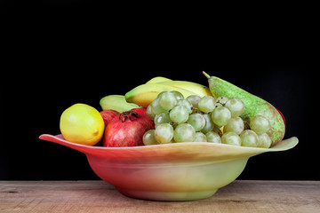 pomegranates and other fruits in a bowl