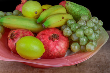 pomegranates and other fruits in a bowl
