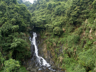 Fototapeta na wymiar Aerial View of Waterfall in the Tropical Rainforest Mountains