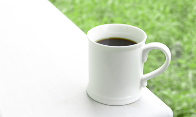 hot coffee white mug on a wooden table natural background,with copy space for your text..