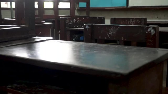 Panning video shot of old classroom towards the whiteboard in public school in Thailand