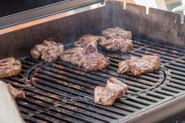 Grillen mit Barbecue Grill Fleisch Steaks auf Sommer Grillparty. Leckere Filets aus Schweinefleisch, Rindfleisch, Putenfleisch, oder Hähnchenfleisch auf Holzkohlegrill oder Gasgrill. Rauchig und zart