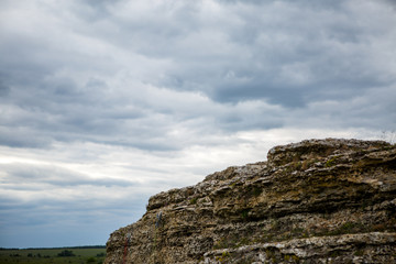 Cliffs with gloomy cloudy evening sky