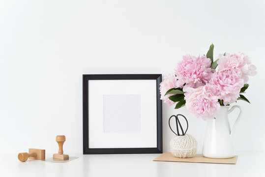 White portrait frame mock up with a pink peonies beside the frame, overlay your quote, promotion, headline