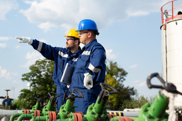 Two workers in the oilfield. Oil and gas concept