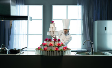 The cook finishes the cake with cream and chocolate