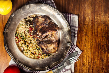 Roasted lamb chops served with bulgur wheat