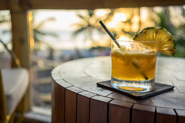 tropical drinks on table with palm trees in background