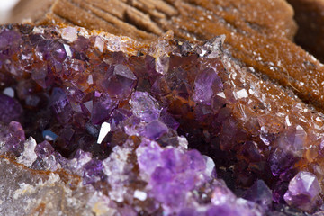 Crystal Stone macro mineral, purple rough amethyst quartz crystals on white background