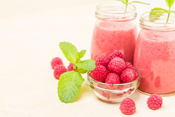 Raspberry smoothie close up photography with fresh summer blended cocktail and ripe berries.