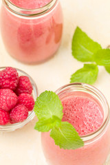 Raspberry smoothie close up photography with fresh summer blended cocktail and ripe berries.