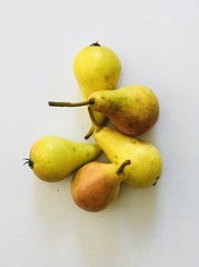 Yellow pears on a light background. Colorful harvest. Delicious fruits/