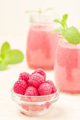 Raspberry smoothie close up photography with fresh summer blended cocktail and ripe berries.