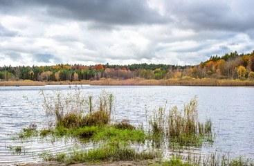 Lake in autumn, landscape with cloudy sky