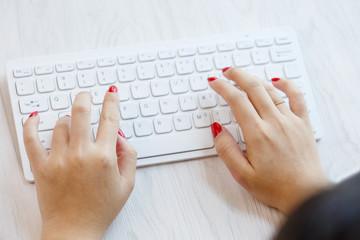 Close-up of young women hitting wireless keyboards