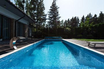 view of modern house with blue swimming pool