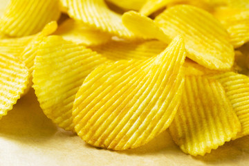 Potato flat chips on paper closeup