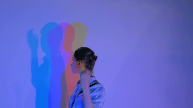 Interactive exposition in science museum. Colored shadows of woman. Science, optical and physics concept