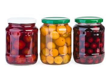 Fototapeta na wymiar Glass jars with preserved apricots, cherries and plums