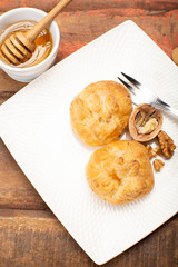 French snack pouches made from puff pastry with fresh soft goat cheese and honing