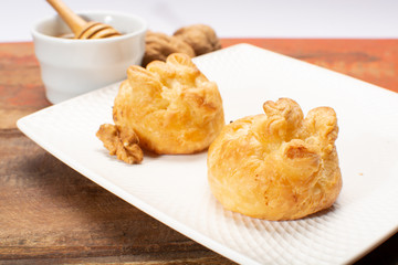 French snack pouches made from puff pastry with fresh soft goat cheese and honing